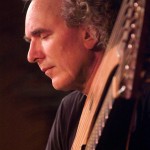 John Doan in concert with harp guitar closeup on stage Jenks Hall Portland Oregon