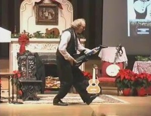 John Doan in concert with his popular Victorian Christmas Show playing electric guitar