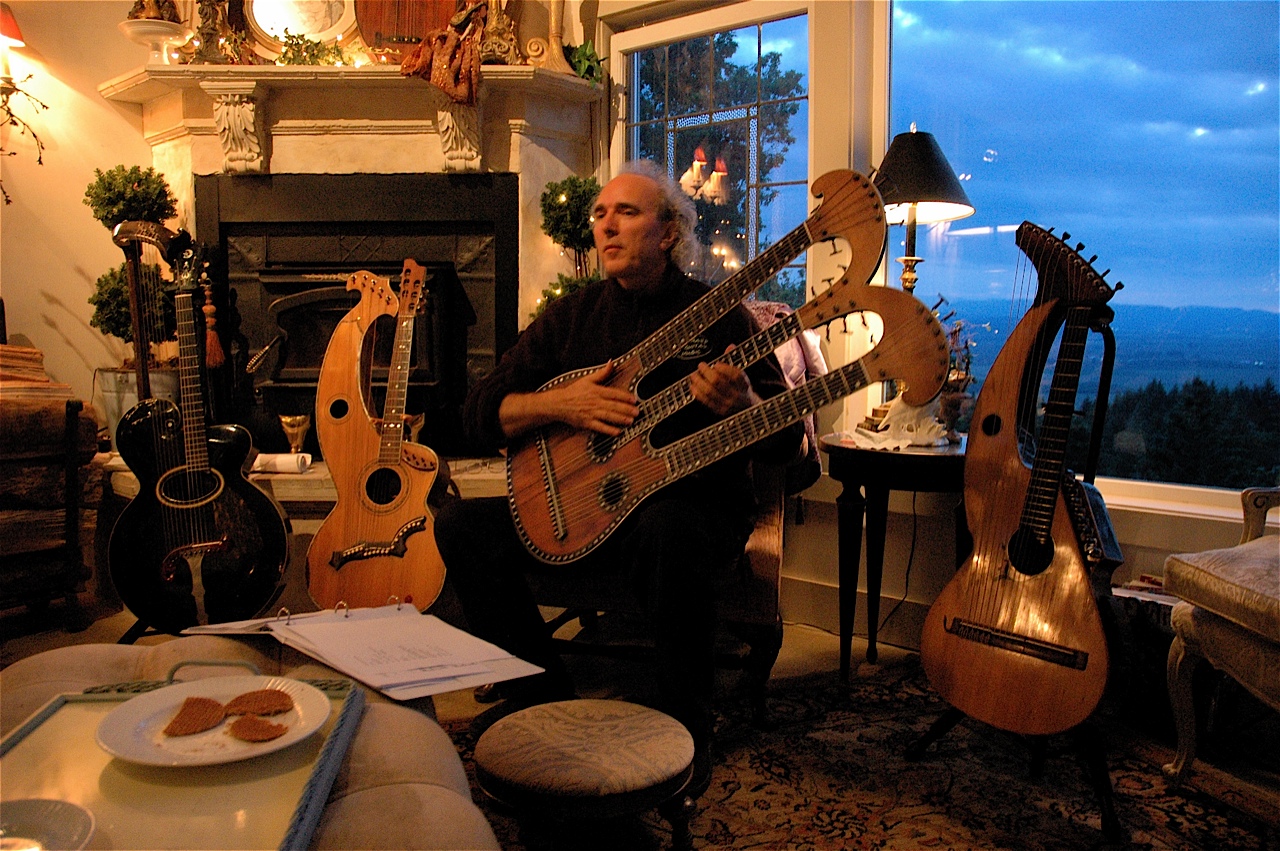 John Doan plays in a home concert with the harpolyre guitar.