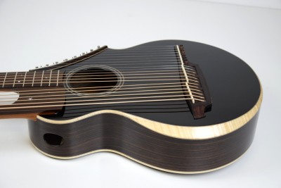 Brunner Harp Guitar from Bass side featuring curly Maple binding with beveled arm rest