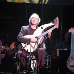 John Doan pefforms on harp guitar in concert.