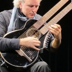 John Doan with Brunner Harp Guitar on stage in concert