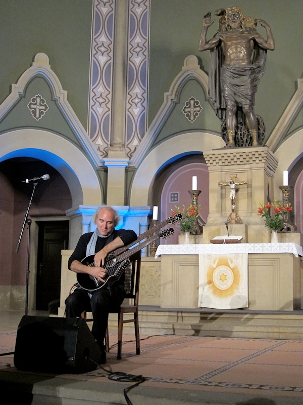 John Doan in Concert playing harp guitar in ancient church