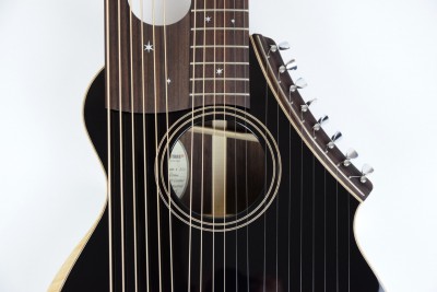 Brunner Travel Harp Guitar close up on face